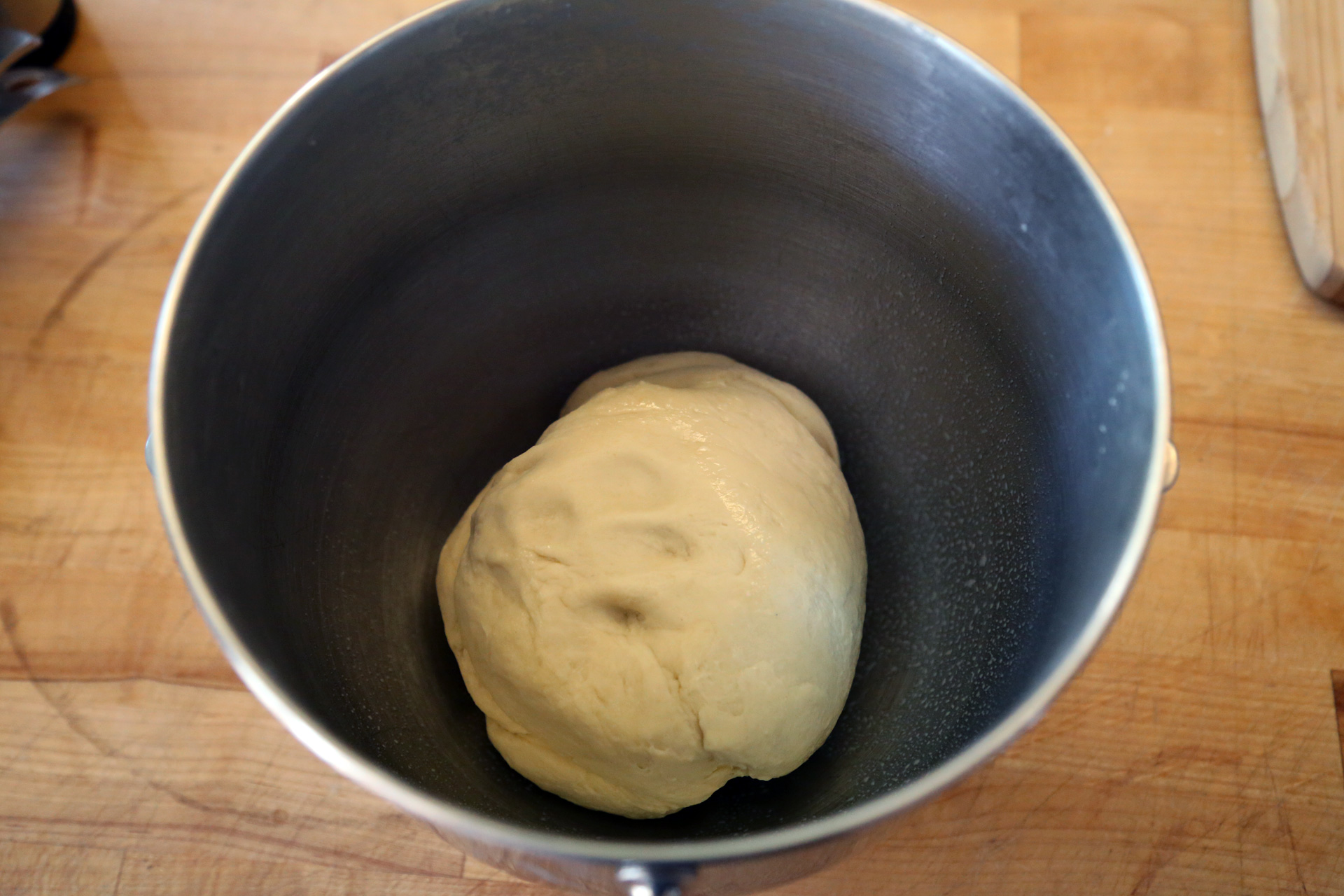 Remove the dough from the bowl, oil the bowl, then return the dough to the bowl.
