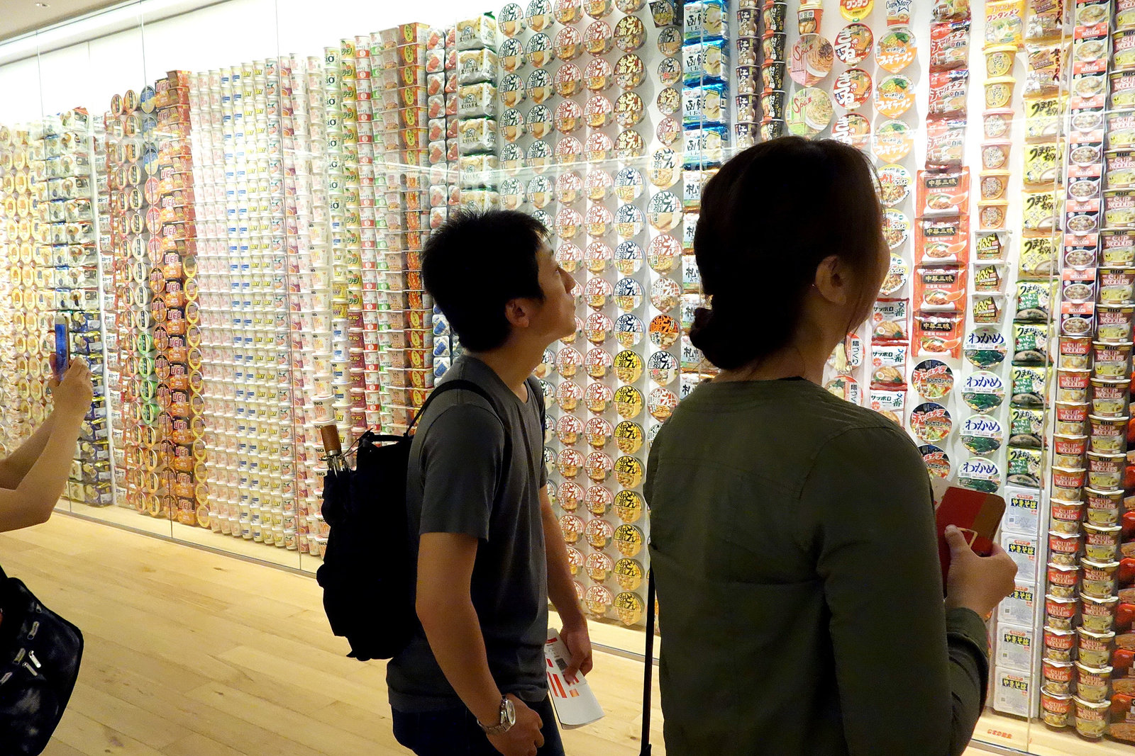 Visitors view a display of Cup Noodles packages from around the world.