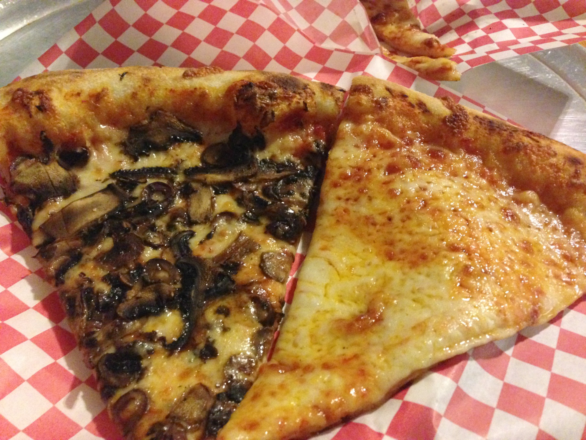 A slice of mushroom and olive and a slice of cheese from Oakland's Leaning Tower of Haddon Hill. 