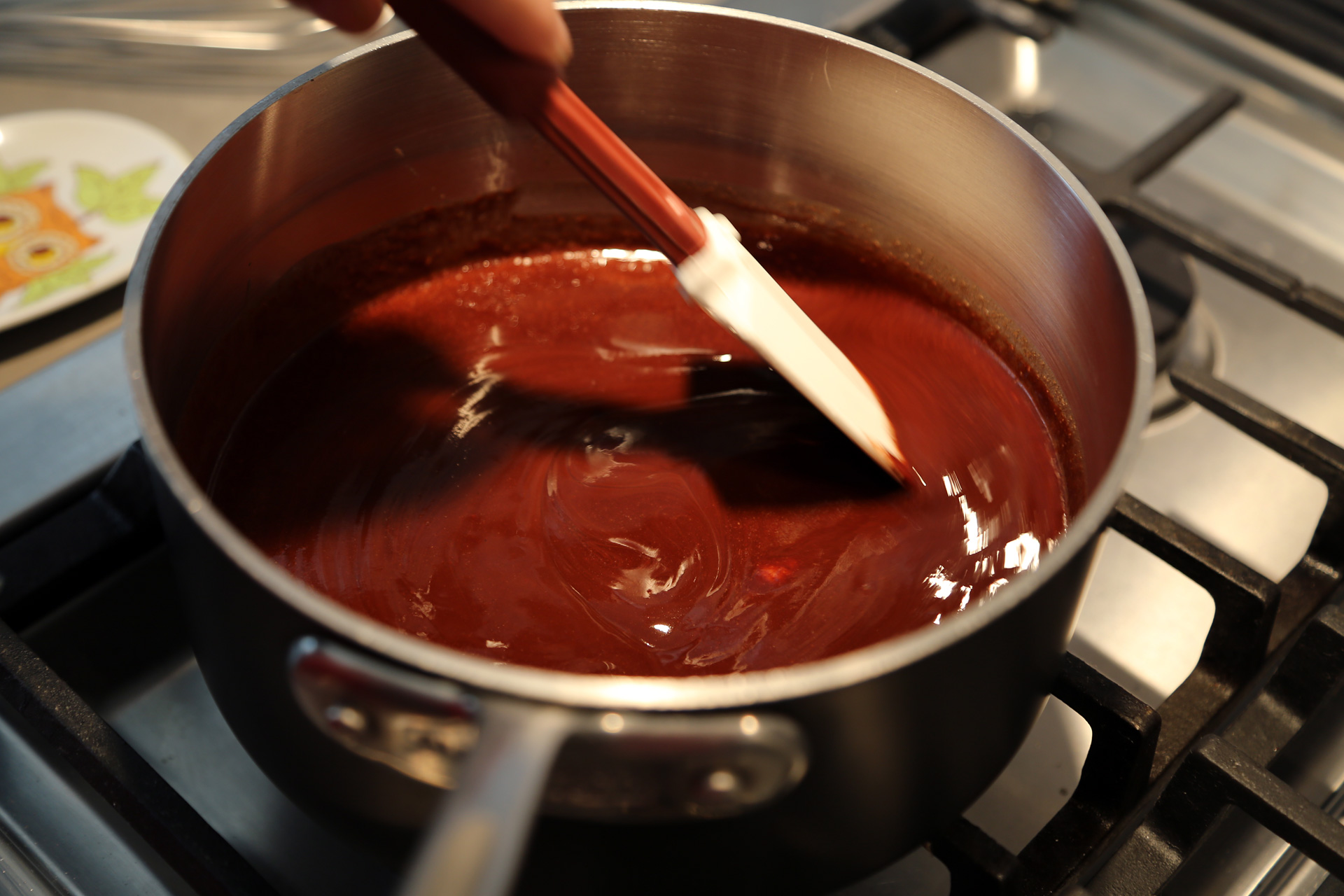 In a medium saucepan over low heat, melt the butter and bittersweet chocolate, stirring, until smooth.