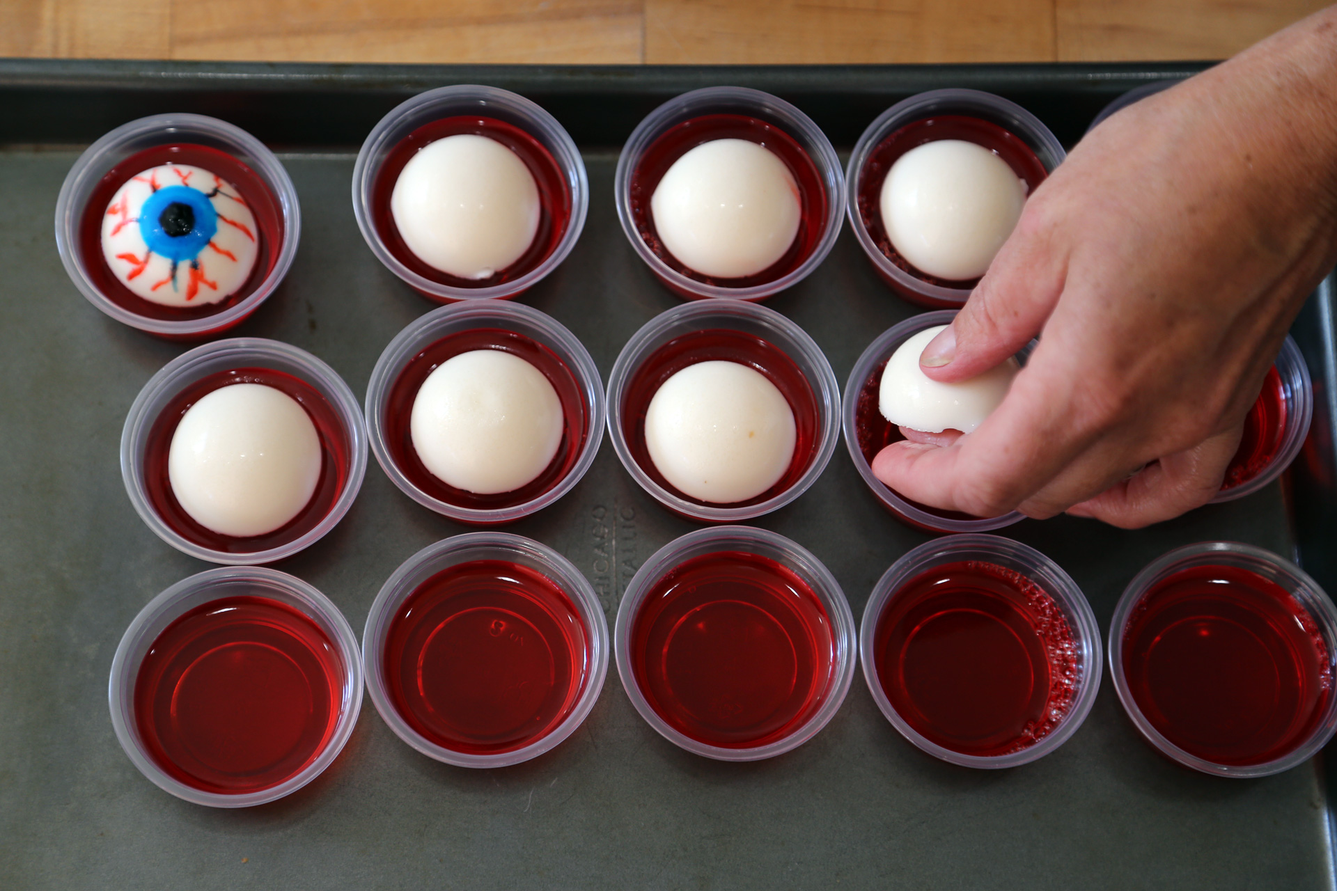 To finish, top each cup of red gelatin with an eyeball.