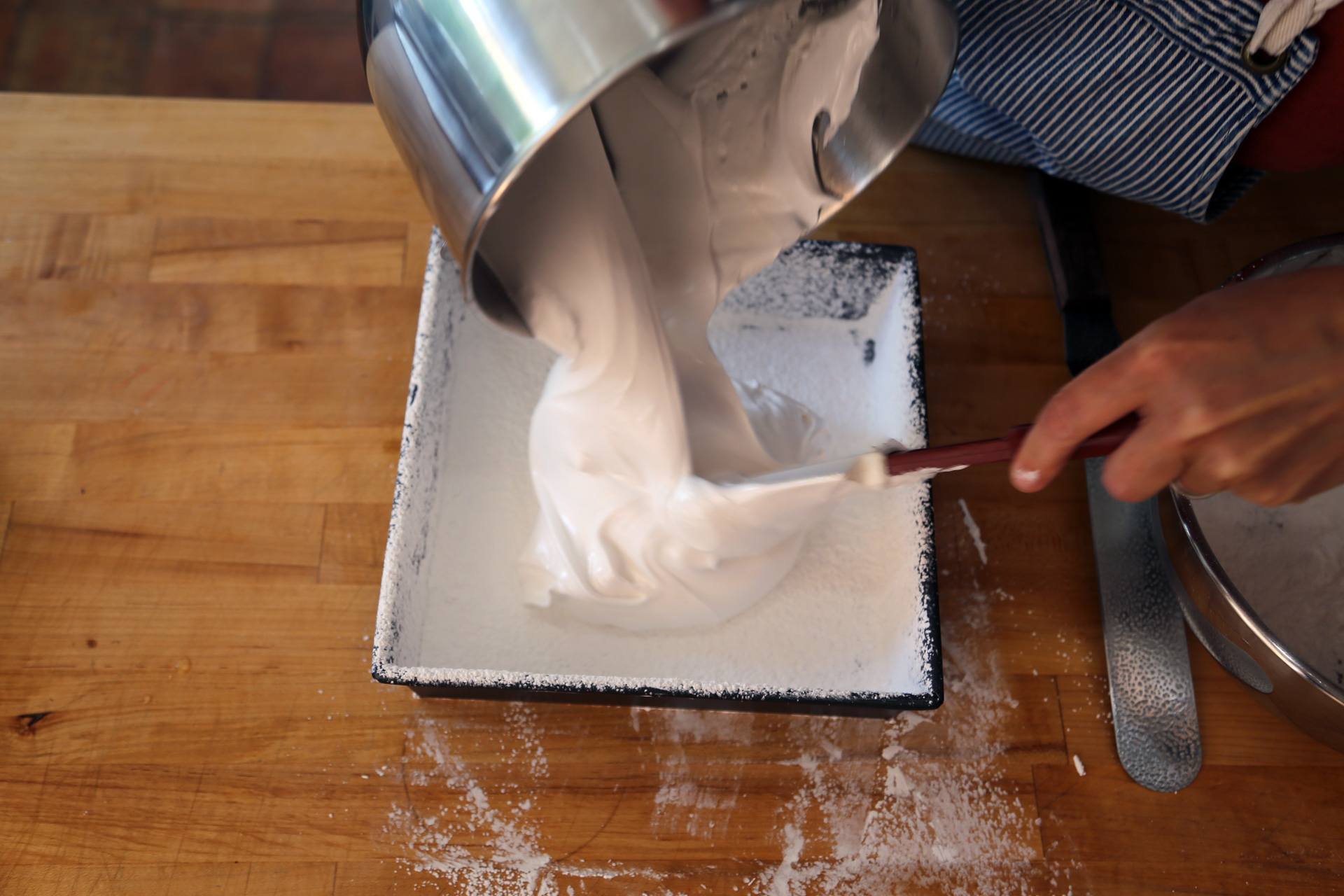 Using a rubber spatula, quickly scrape the marshmallow mixture into the coated pan.
