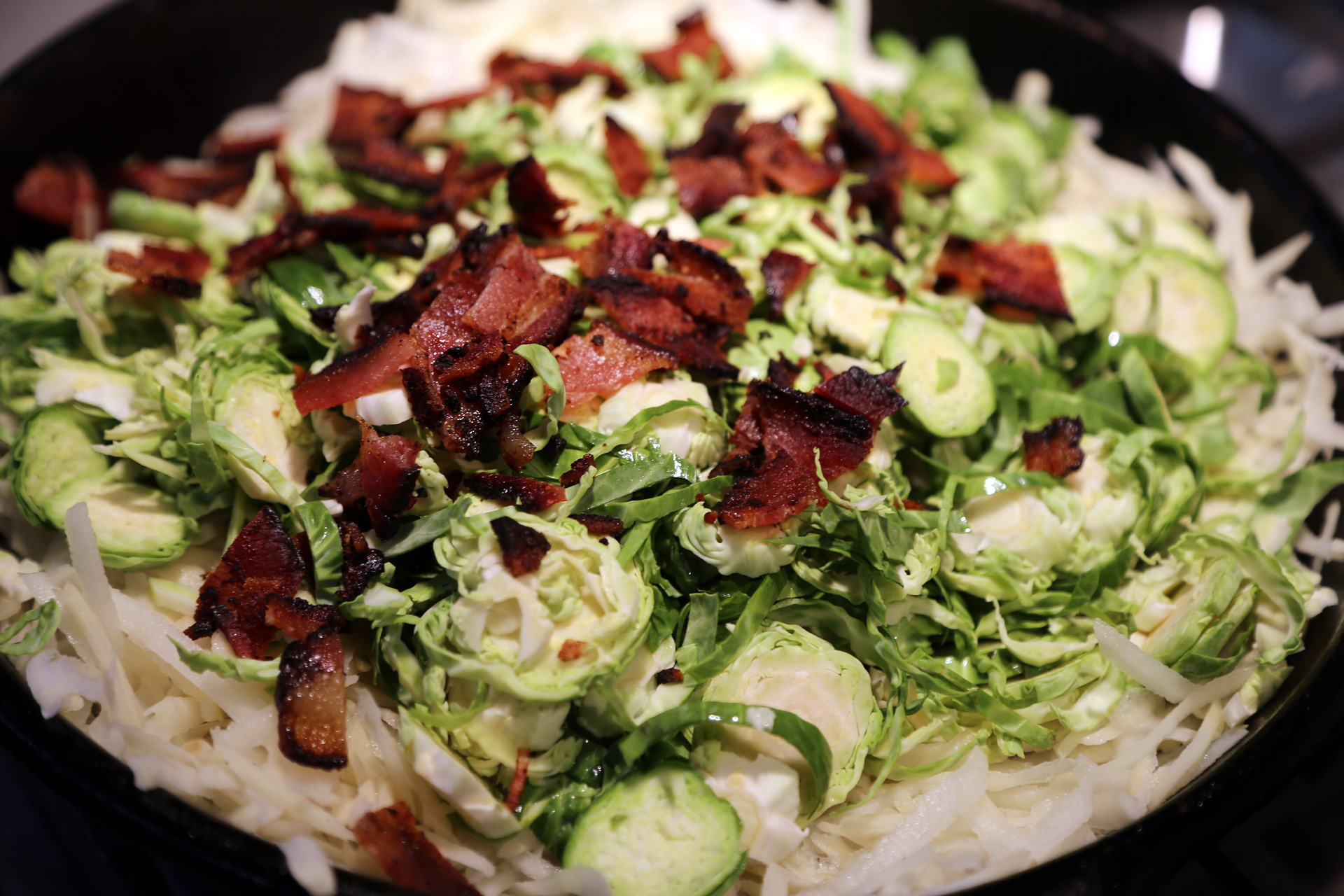 Add potatoes, Brussels sprouts, and crumbled bacon, in that order.