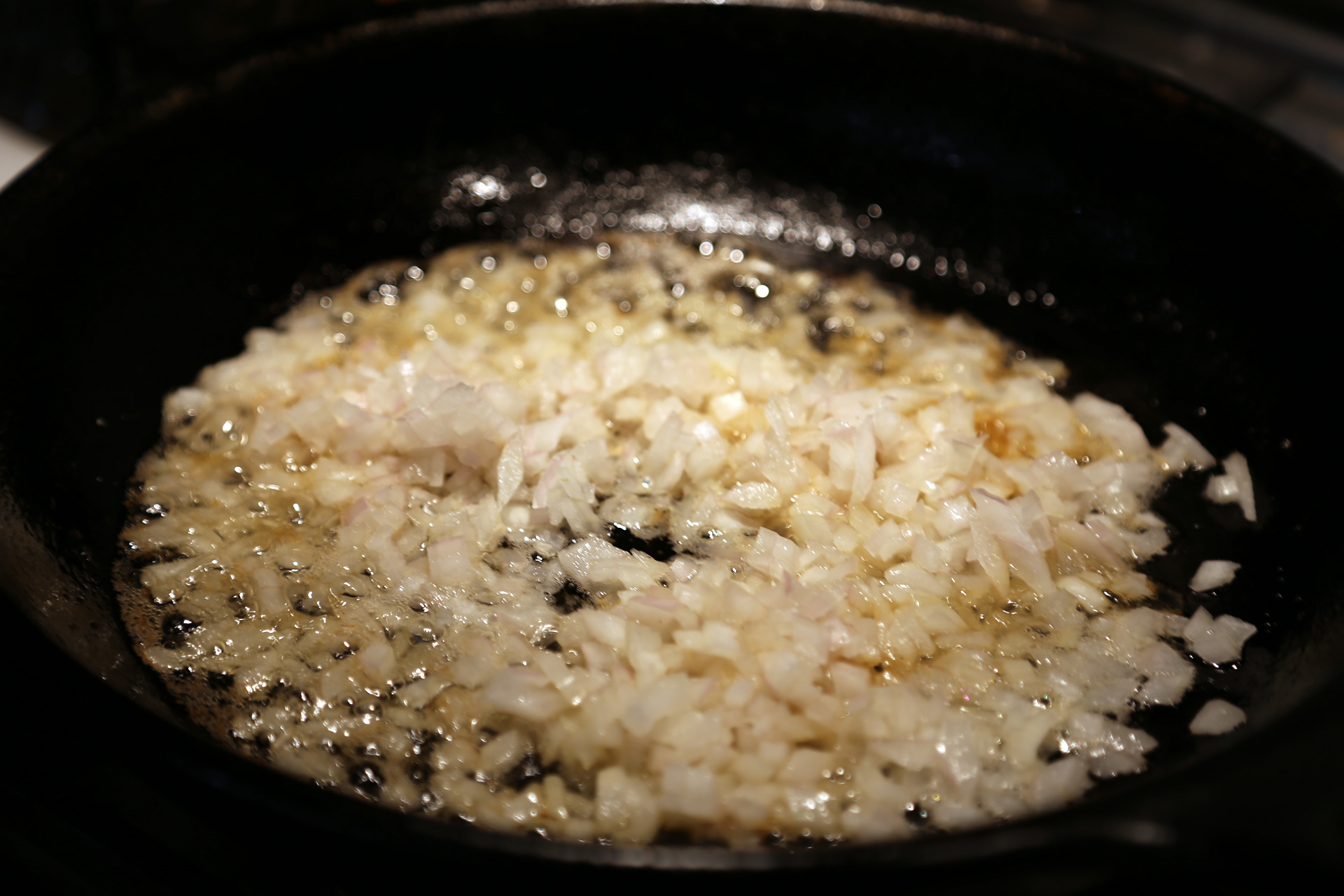 You should have about 3 tablespoons bacon fat in the pan. If not, add enough olive oil to make 3 tablespoons total (or pour off any excess). Heat the pan over medium heat. Add the onion
