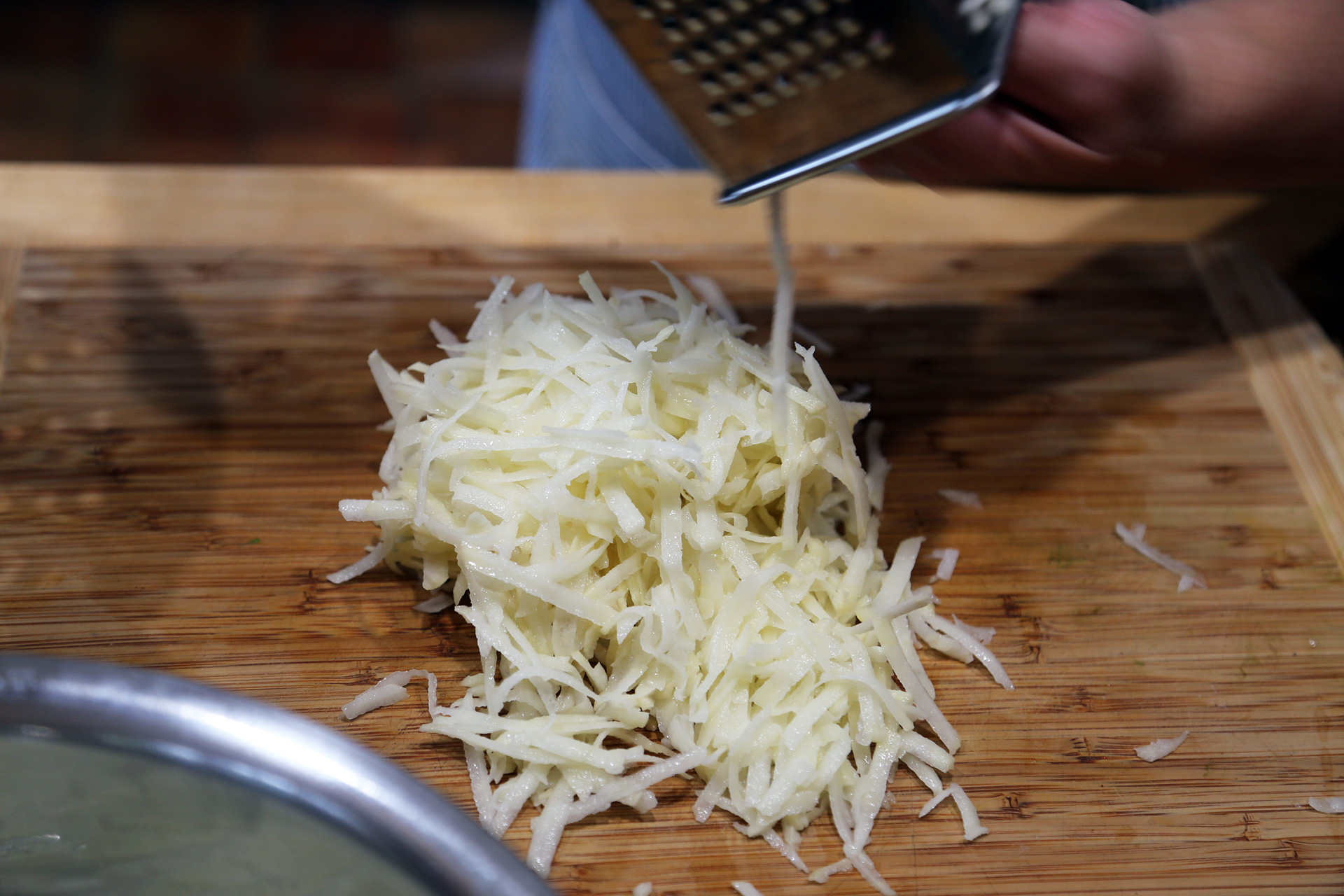 Shred the potatoes using the shredder insert in your food processor or by hand on the large holes of a box shredder-grater. 