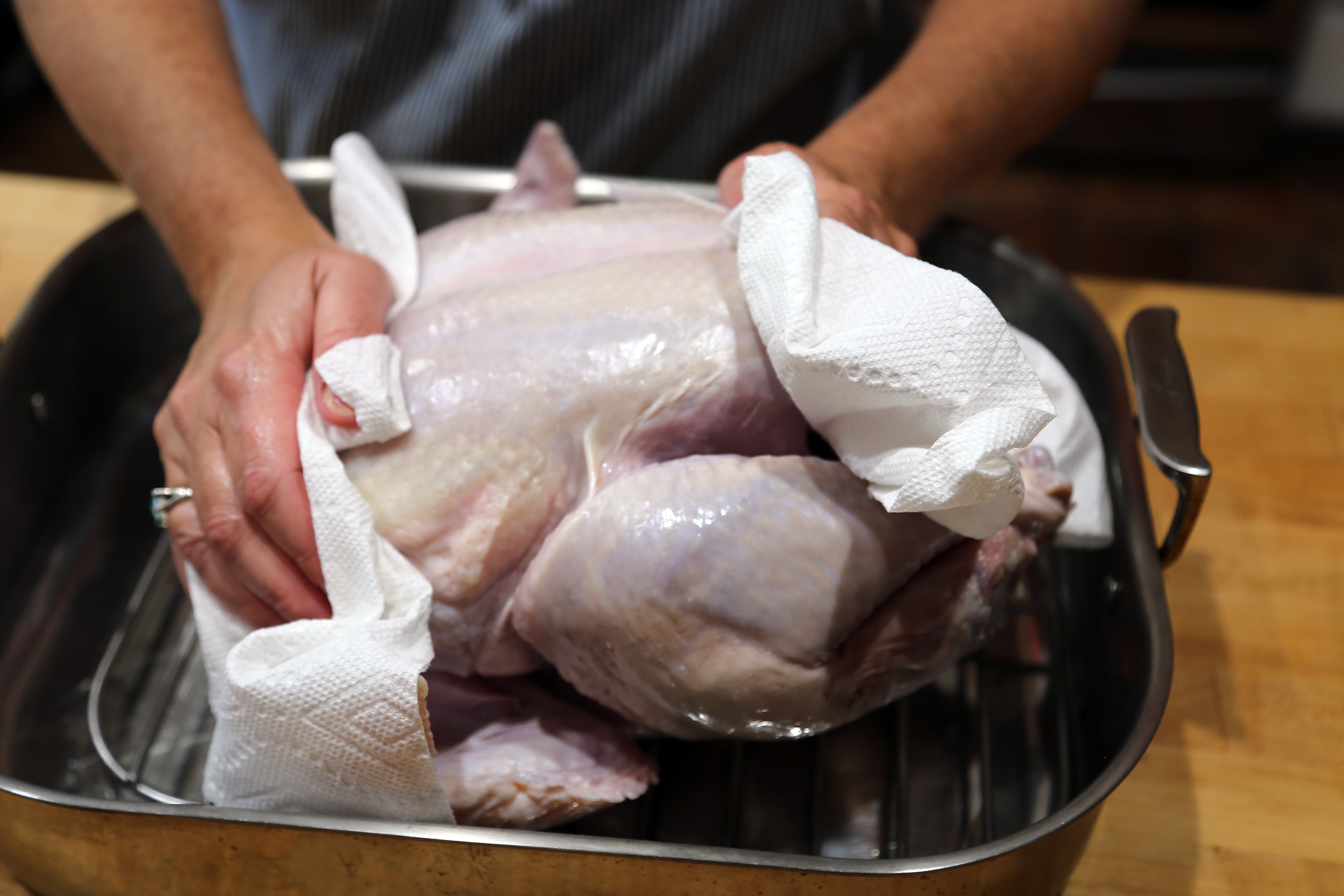 One to two days before roasting: Dry the turkey with paper towels and place it in a roasting pan or a baking pan.