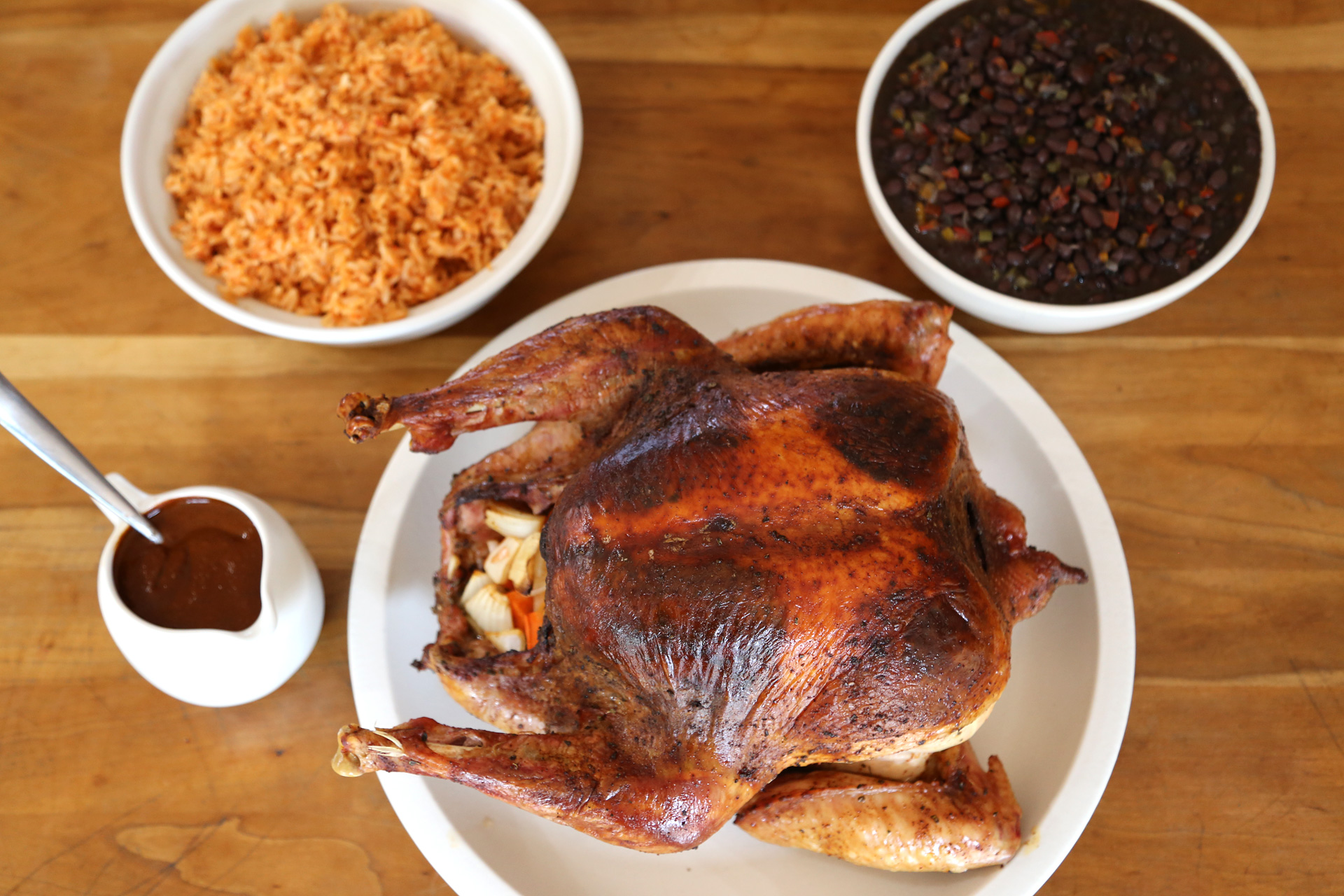 Chile-Rubbed Roast Turkey served with Savory Black Beans, Mexican Rice and Mole Gravy