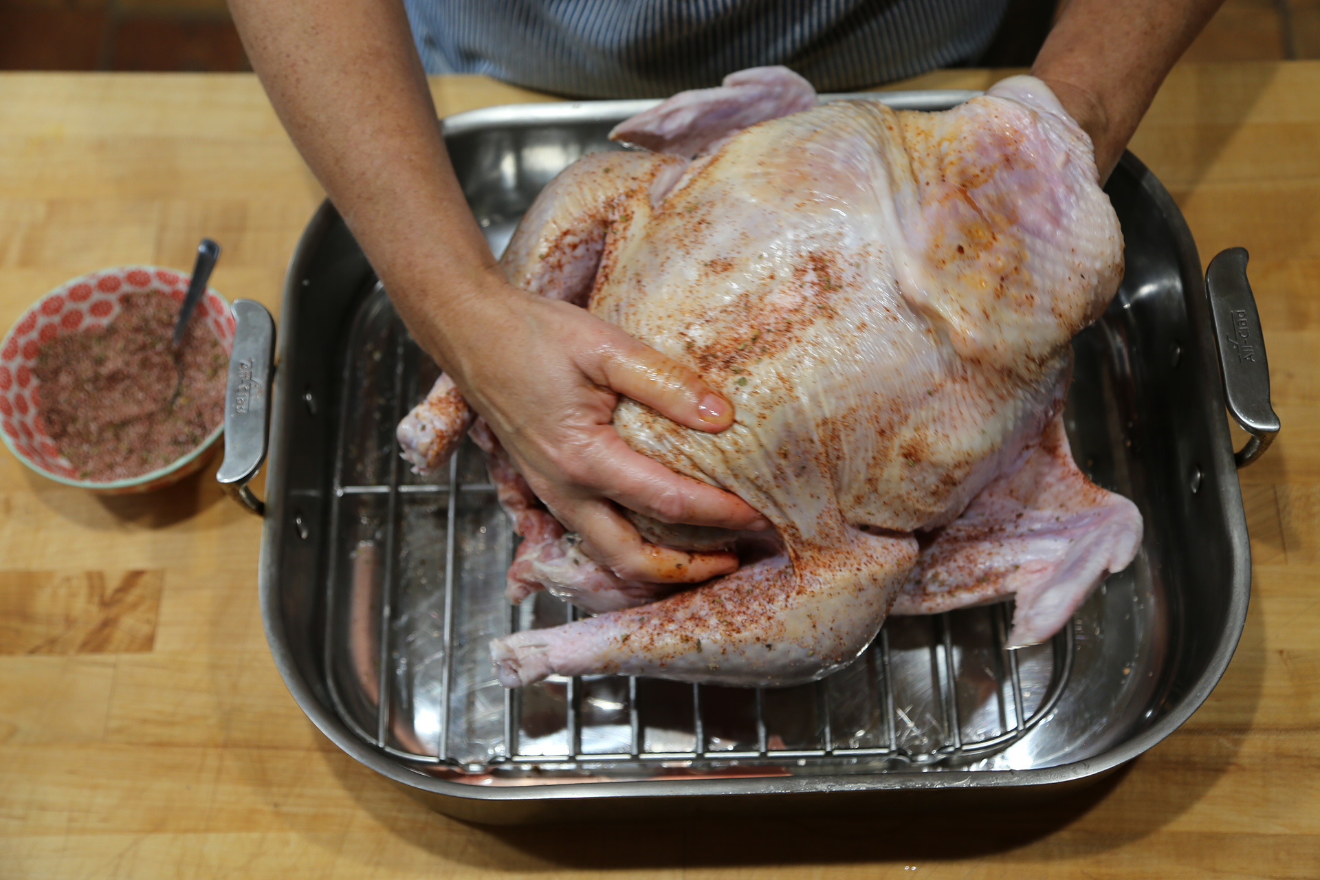 In a bowl, mix together the salt, chile powder, and oregano. Rub the salt mixture all over the turkey, under and over the skin and in the cavities.