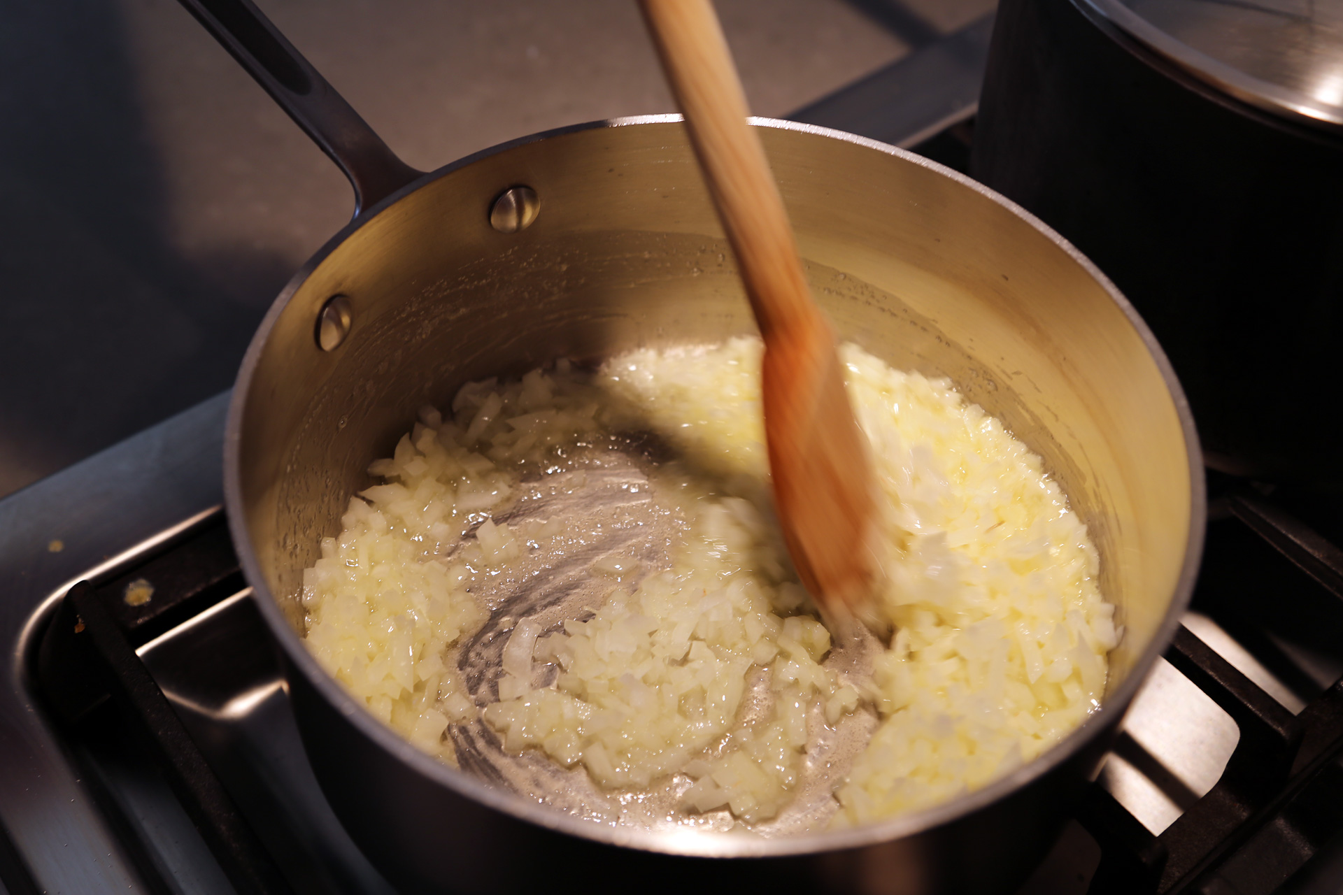 To make the gravy, in a large saucepan, melt the butter over medium-low heat. Add the onion and a pinch of salt and cook.