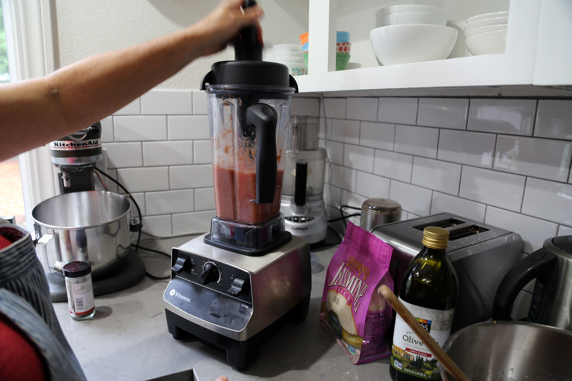In a blender, puree the tomatoes with juices, onion, and garlic until smooth. 