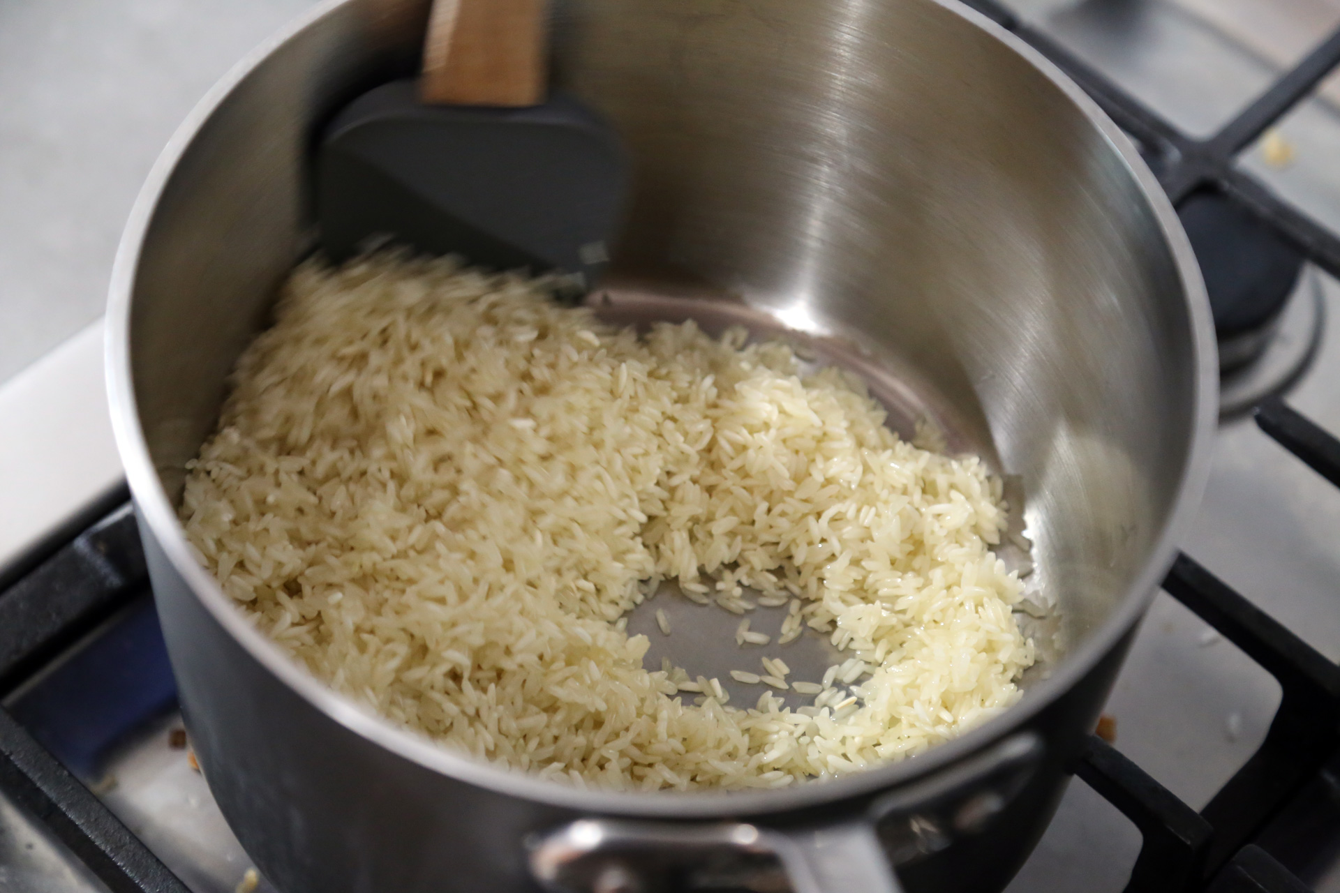 In a large heavy saucepan or Dutch oven, warm the olive oil over medium heat. Add the rice and cook, stirring often, until the rice becomes golden, about 5 minutes.