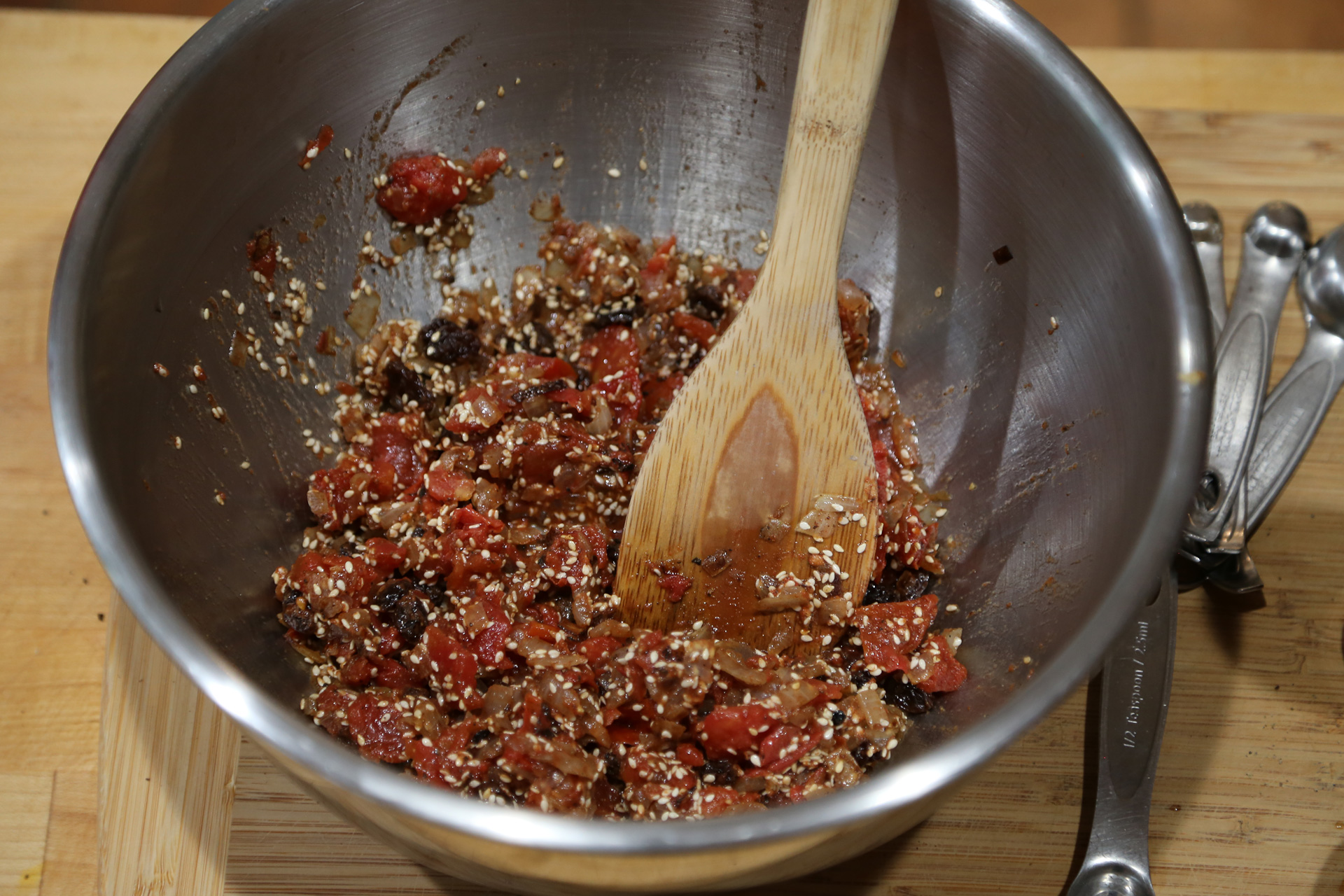 Add the diced tomatoes, cinnamon, anise, salt, black pepper, and cloves. Set aside