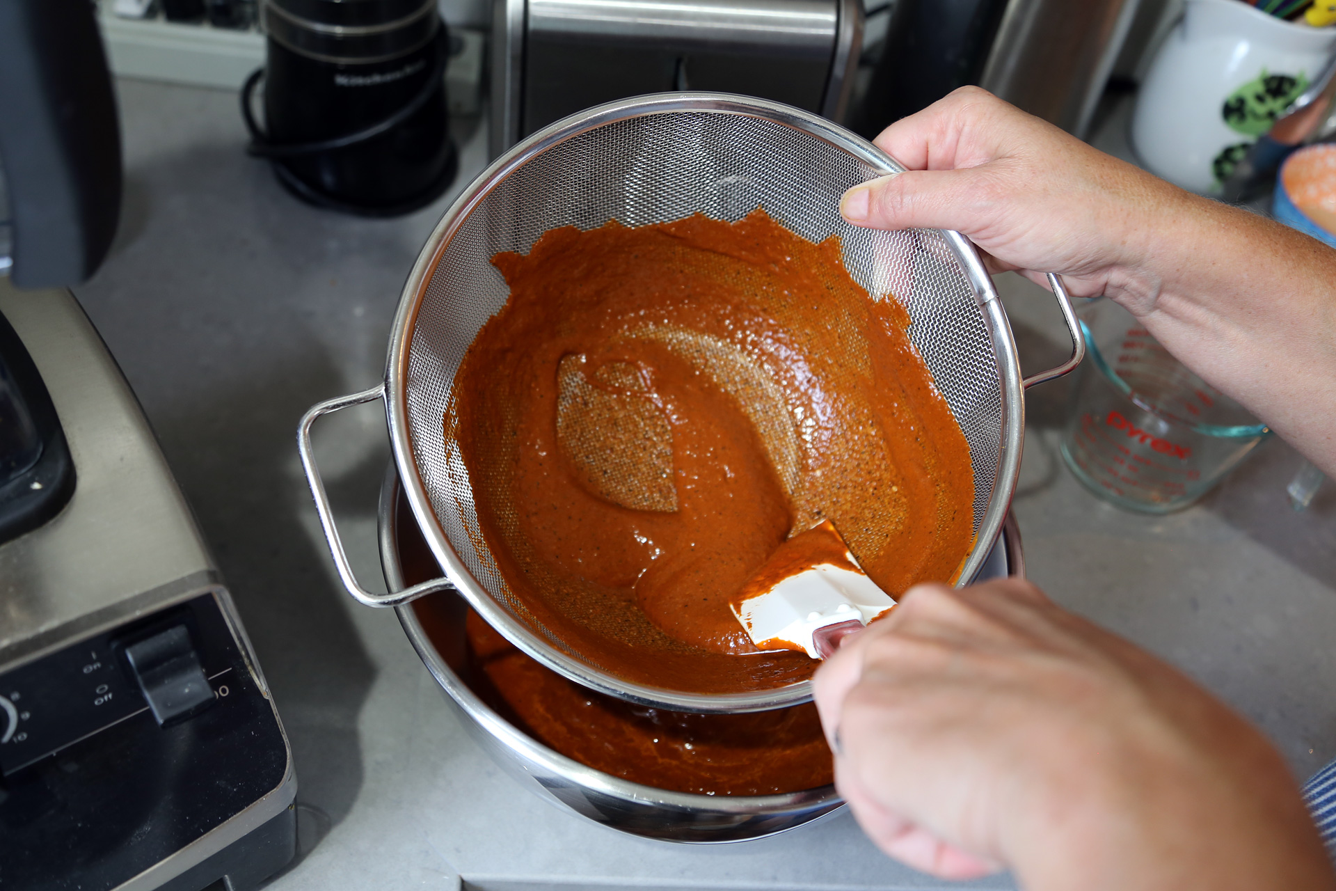 Place a fine-mesh sieve over a bowl and strain the mixture through the sieve, using a rubber spatula to press it through.