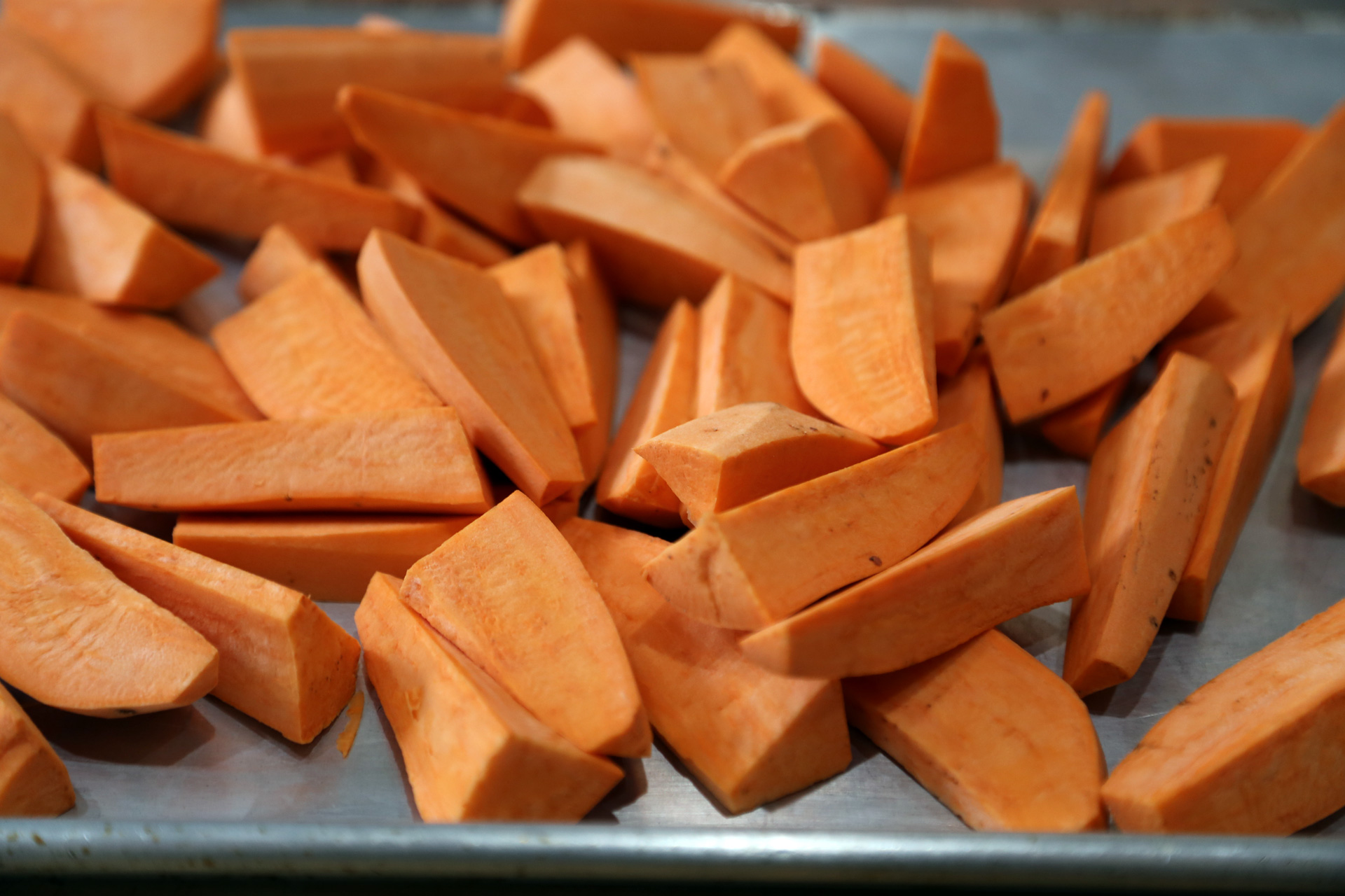 Cut the yams in half crosswise, then cut into equal-sized wedges, each about 1 by 3 inches.