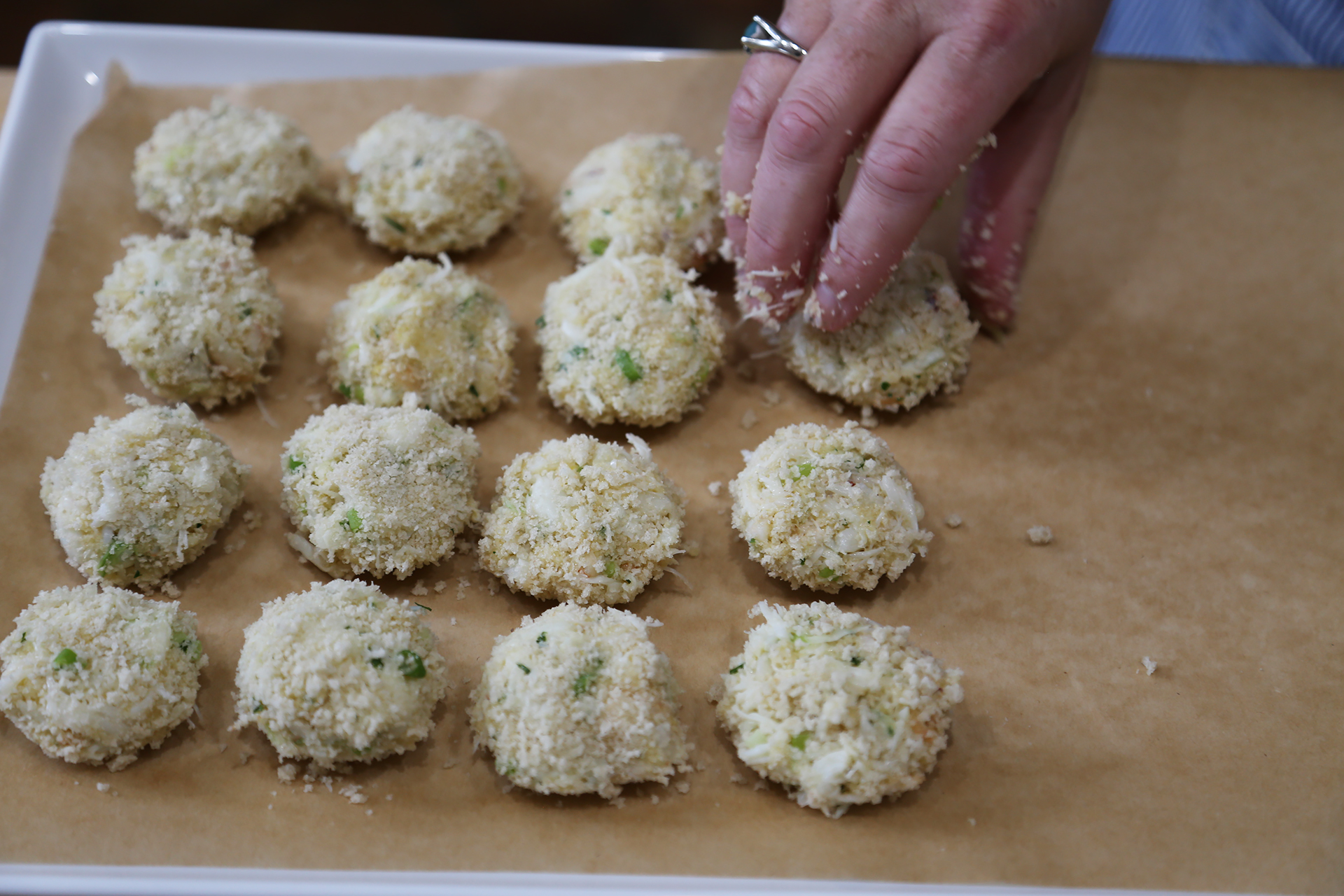 Form into approximately 40 mini crab cakes, each about 1 tablespoonful, pressing them together to hold.
