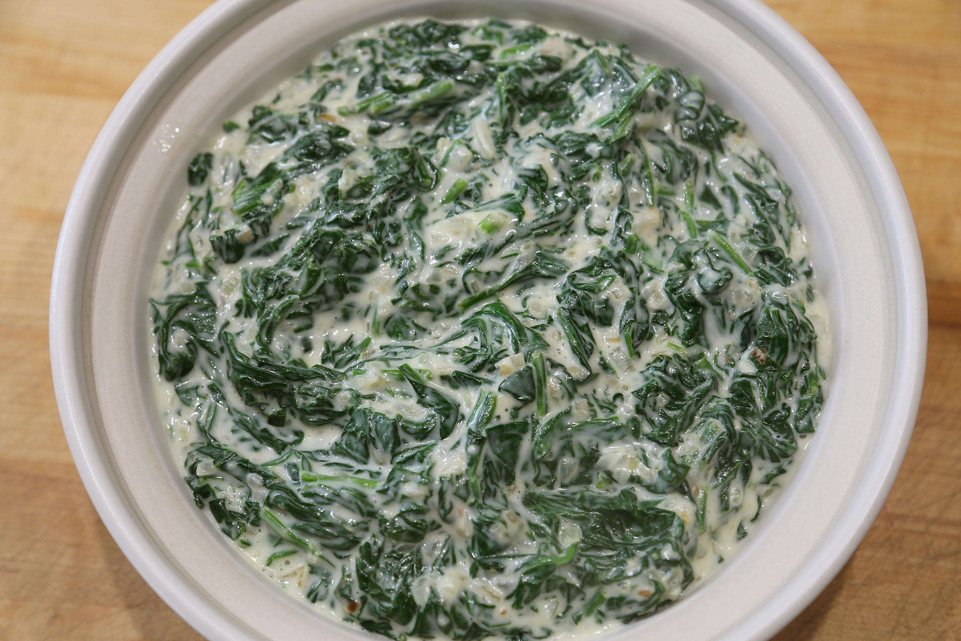 Serve the creamed spinach at once.