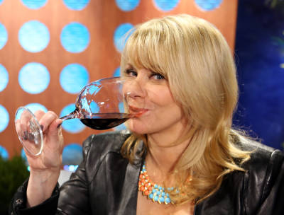 Host Leslie Sbrocco tasting wine.