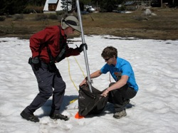 Surveyor Frank Gehrke takes on last poke at the season's shrinking snow pack. Photo by Craig Miller.