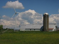 Windmills dwarf a dairy farm in upstate New York. Photo: Craig Miller