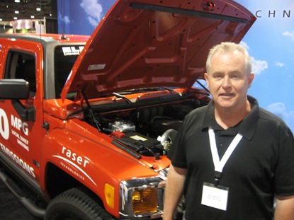 Jim Spellman of Raser Technologies, standing in front of the 100-mpg Electric Hummer. Photo: Rob Schmitz