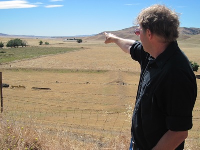 Standing at the valley's north end, BLM ecologist Mike Westphal points to where 2,000 acres might be covered in PV solar panels. (Photo: Craig Miller)