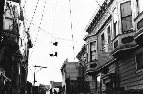 Shoes hang from wires in the Mission.