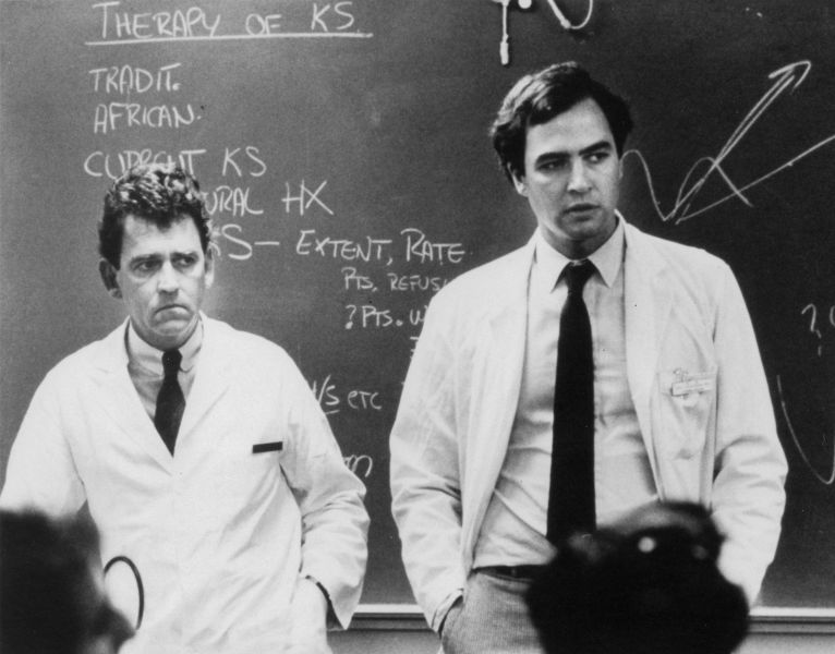 In 1981 Marcus Conant, MD (left) and Paul Volberding, MD (right) discuss Kaposi's Sarcoma, a disease that became one of the original AIDS-defining illnesses. 