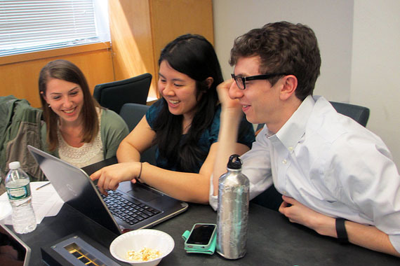 (Left to right) Christine Schindler, Mary Quien and Micah Timen hold a study session. Timen worked as an accountant before medical school; his database project tracked the relative costs of a hip replacement throughout New York compared to the relative costs of a fast-food hamburger.