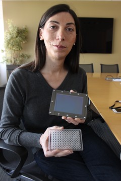 Emily Leproust, co-founder of Twist Bioscience, holds one of the company's 10,000-well plates in her left hand. 