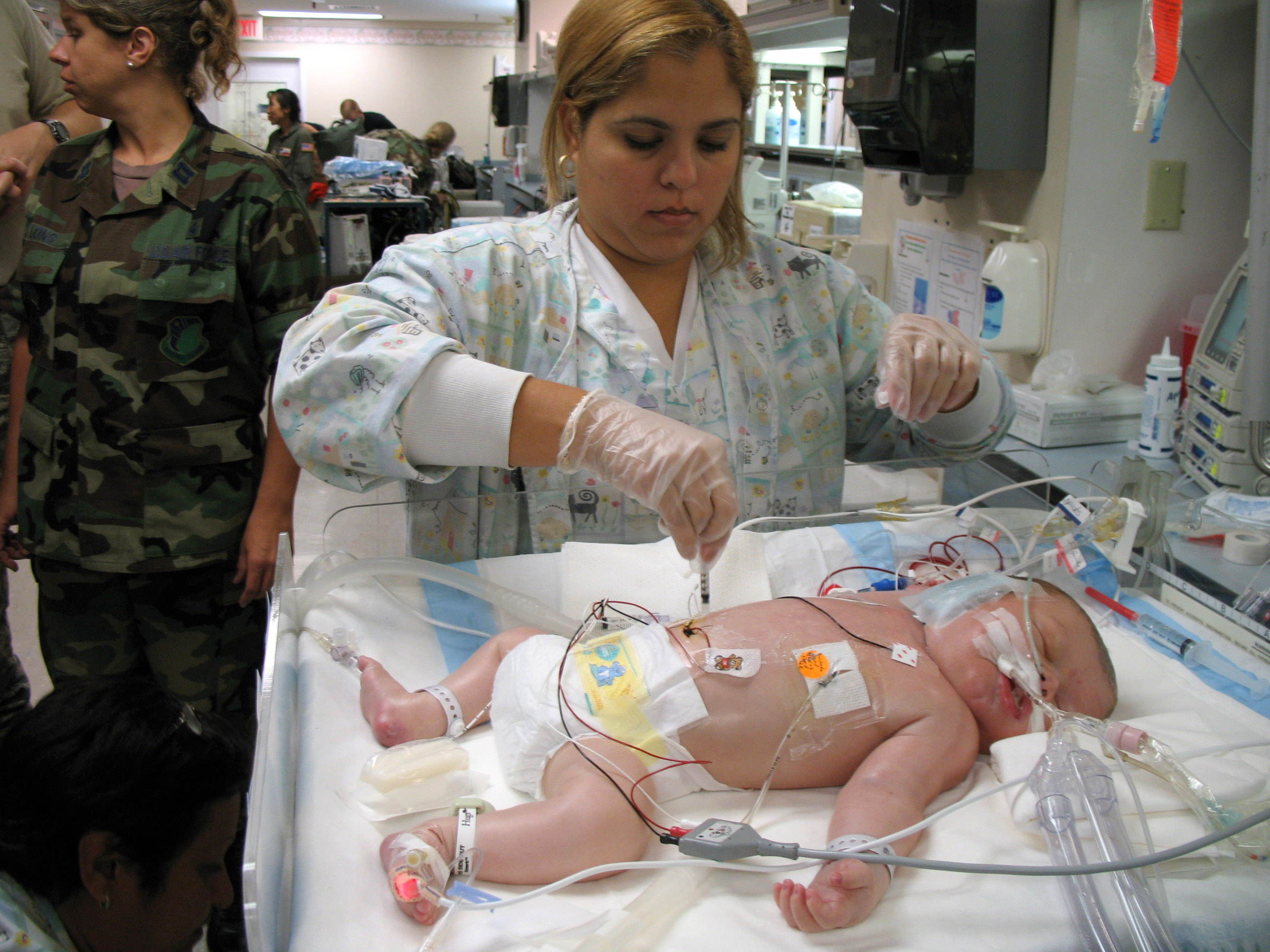 Respiratory therapist Michelle Sirra takes a blood sample from 3-day-old Stuart Parker in preparation for transfer to an Extracorporeal Membrane Oxygenation unit on Friday, July 21, in San Juan, Puerto Rico. An ECMO team comprised Air Force and Army medical specialists from the Wilford Hall Medical Center at Lackland Air Force Base, Texas, flew to Puerto Rico to transport Stuart to San Antonio for more advanced care. 