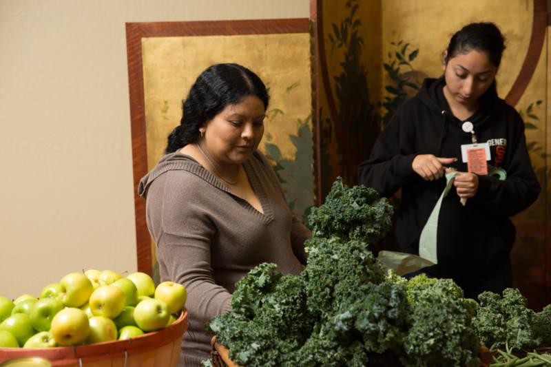 Clients in a pilot program for pregnant women with diabetes choose from an array of fresh fruits and vegetables, at the Community Wellness Program Center at Zuckerberg San Francisco General Hospital.