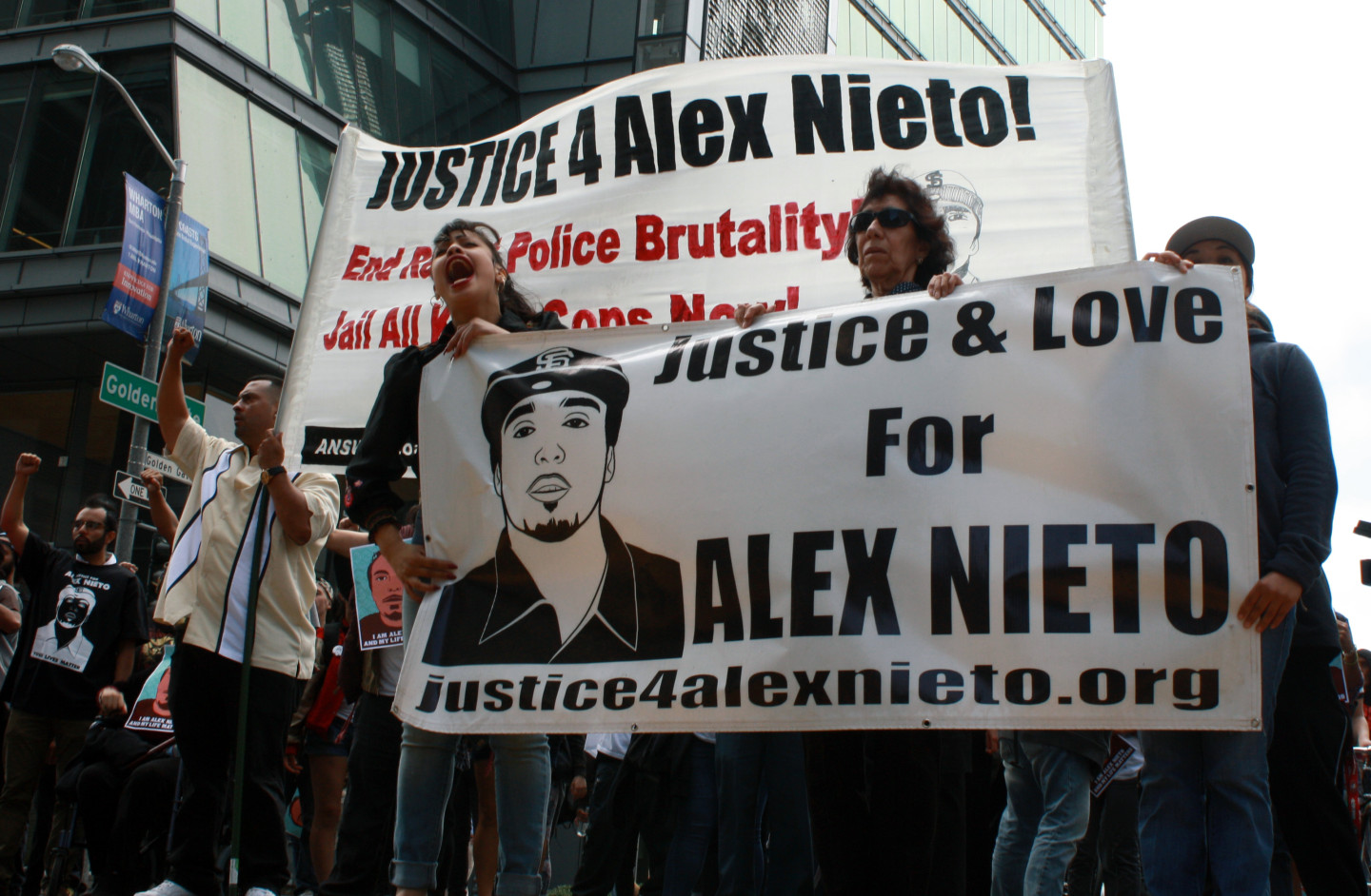 Alejandro Nieto’s mother Elvira Nieto (center) leads an Aug. 22 march to announce the filing of a lawsuit against the city over the fatal shooting of her son. (Alex Emslie/KQED)