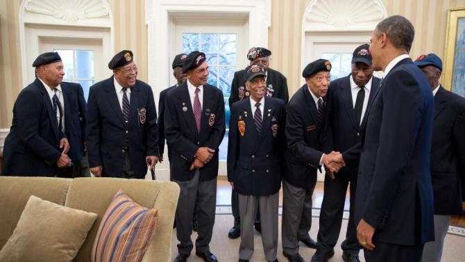 President Obama greets a group of black veterans at the White House.