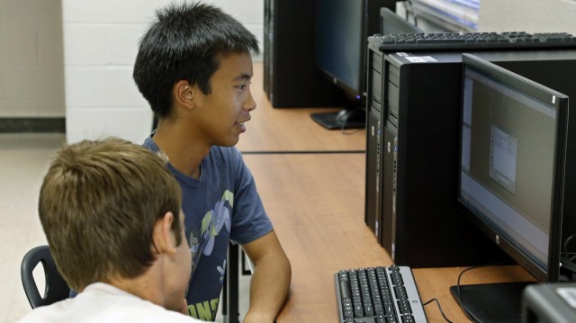 Alex Tu, left, an Advanced Placement student, works during a computer science class in Midwest City, Okla. There's been a sharp decline in the number of computer science classes offered in U.S. secondary schools. 