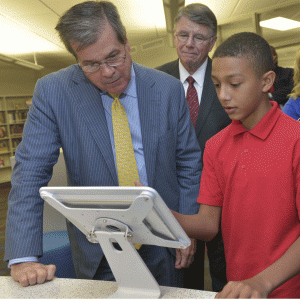 Nashville Mayor Karl Dean (left) with a student at Dupont Tyler Middle School. The school participates in the Limitless Library program and recently had its library renovated through the program.   