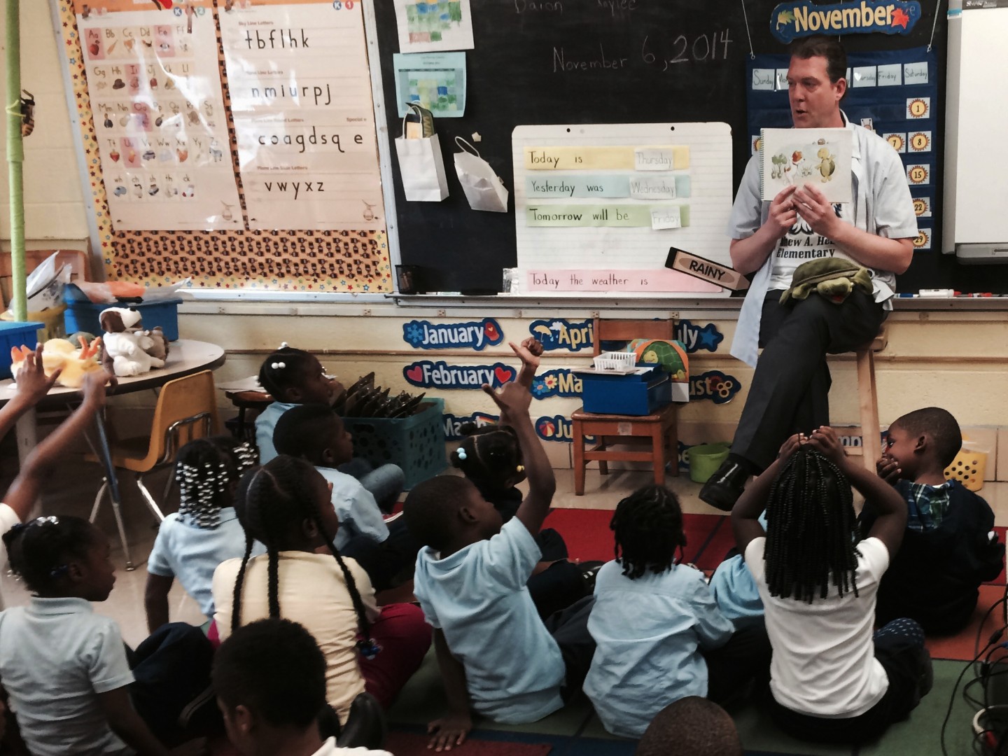 Thomas O'Donnell reads about Twiggle the Turtle to his kindergartners at Matthew Henson Elementary School in Baltimore. (Elissa Nadworny/NPR)