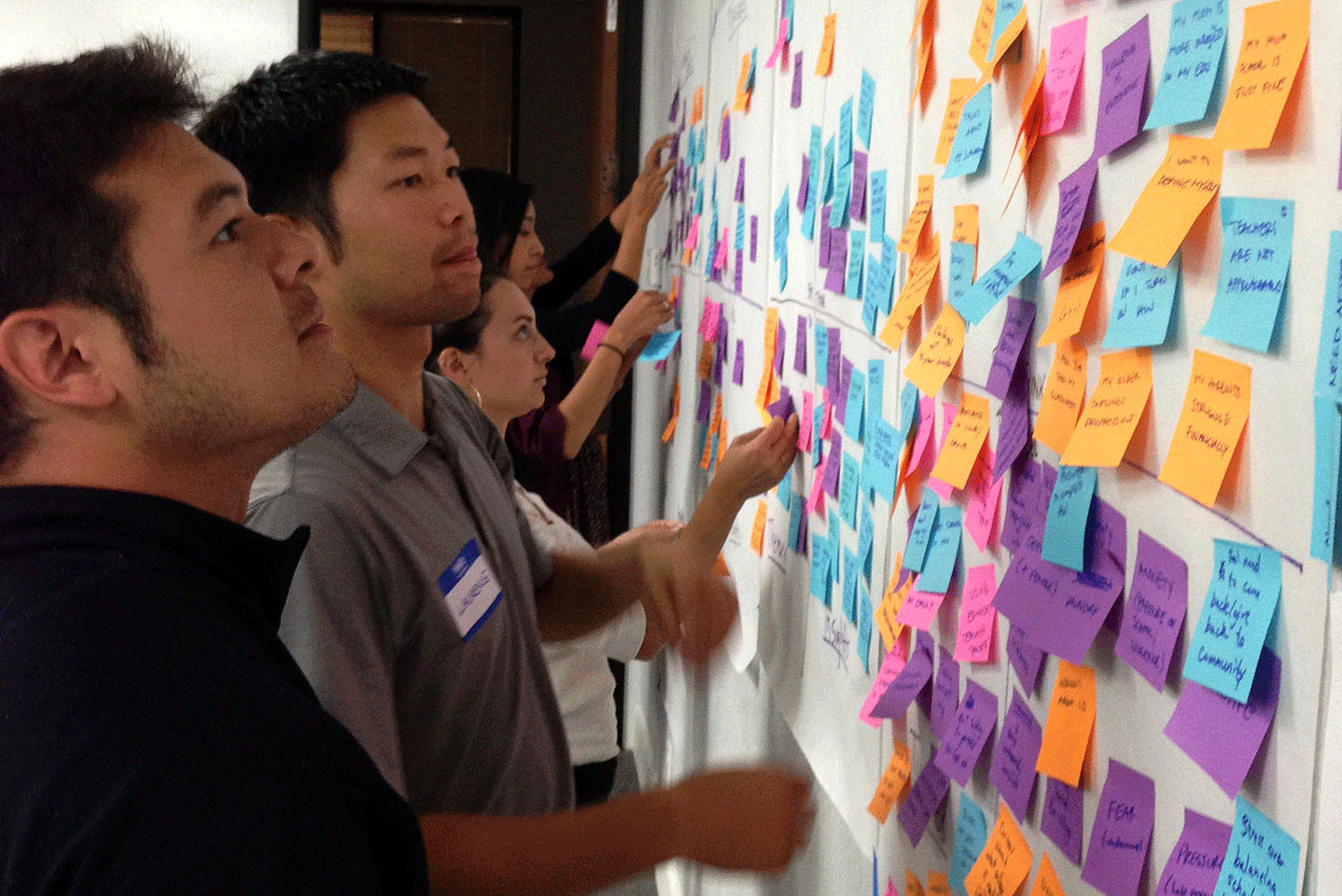 High School design team members check out ideas written on post-it notes during a brainstorming session. (Photo: Courtesy of Will Eden) 