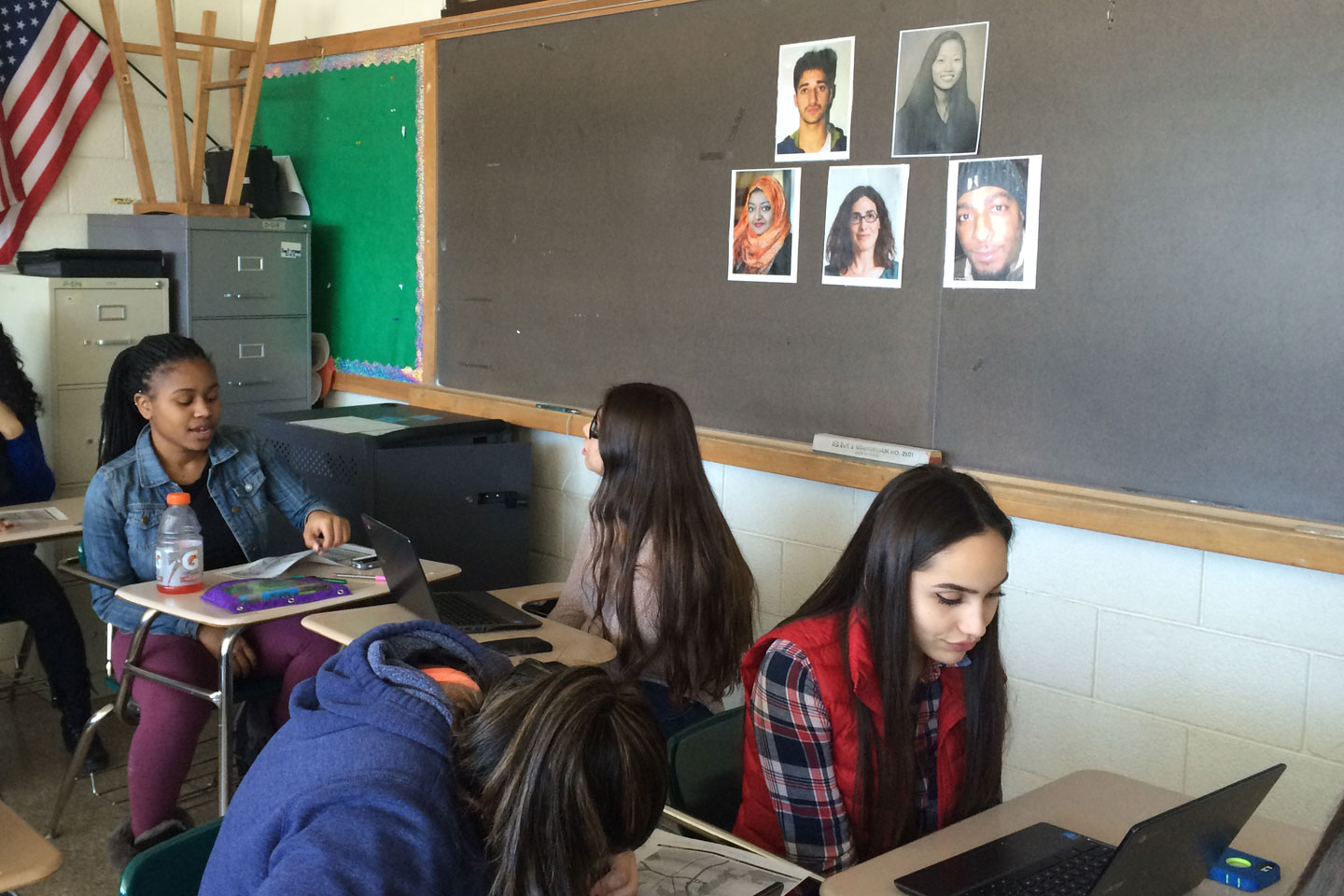 Students at Norwalk High School discuss the Serial podcast, while images of key players loom on the wall, including Adnan Syed and Sarah Koenig. Credit: Credit: Sabrina Hiller.