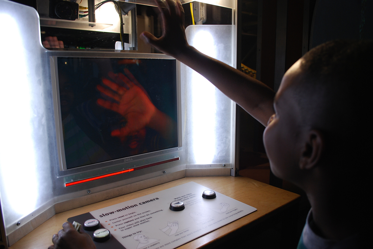 Taivon Wilson, a sixth-grade student at Franklin Middle School in Vallejo, Calif., waves at a high-speed camera that plays back movements in extreme slow motion during a field trip to The Exploratorium. 
