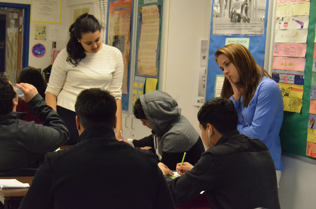 Teaching resident Grace Tesfae (left) working with students at Cesar Chavez Academy High School in Detroit. The classroom teacher, Cortney Kosmala-Jackson, is on the right. 