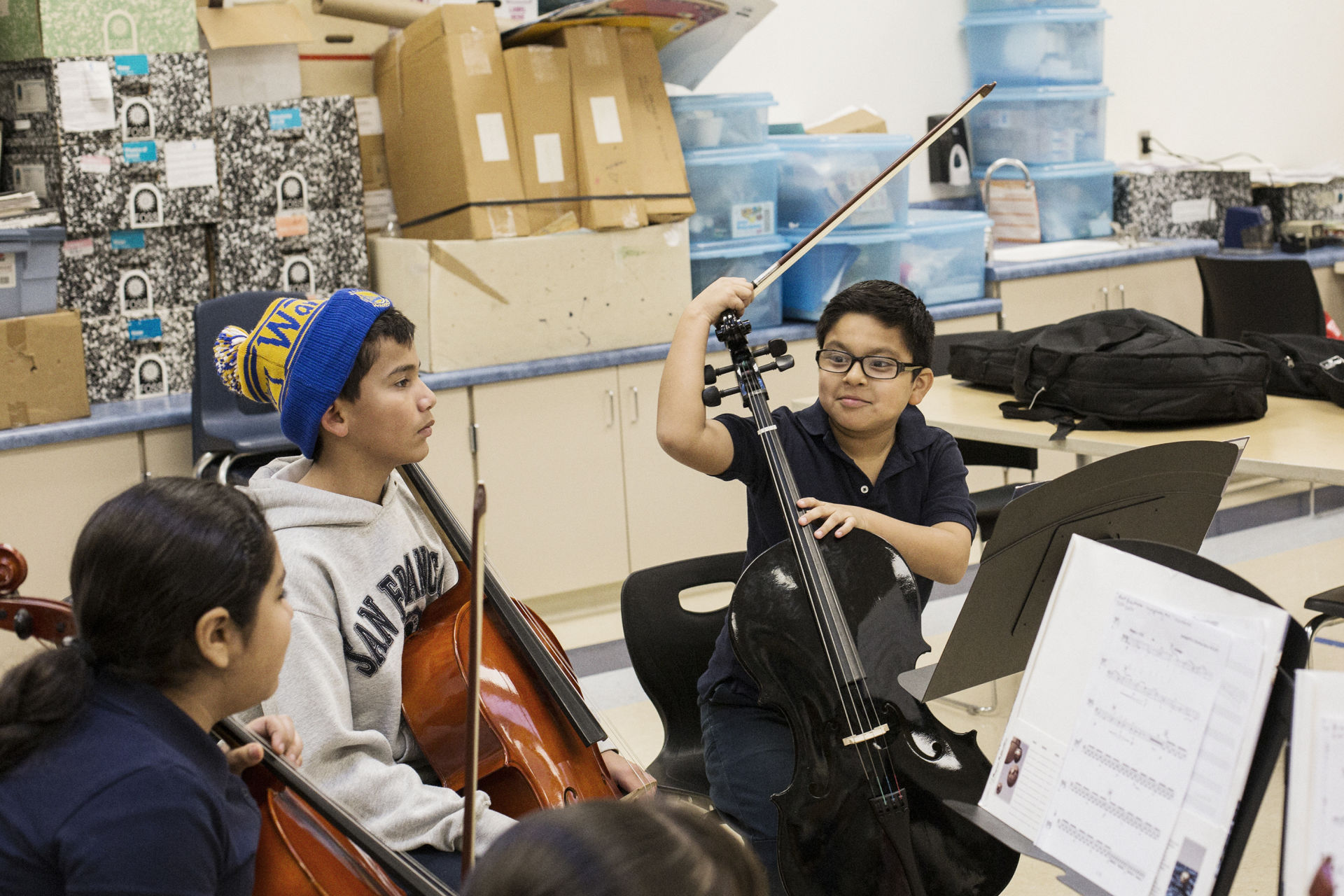 Carlos Garcia (right) chats with other students during the Sound Minds after-school program at Downer Elementary.