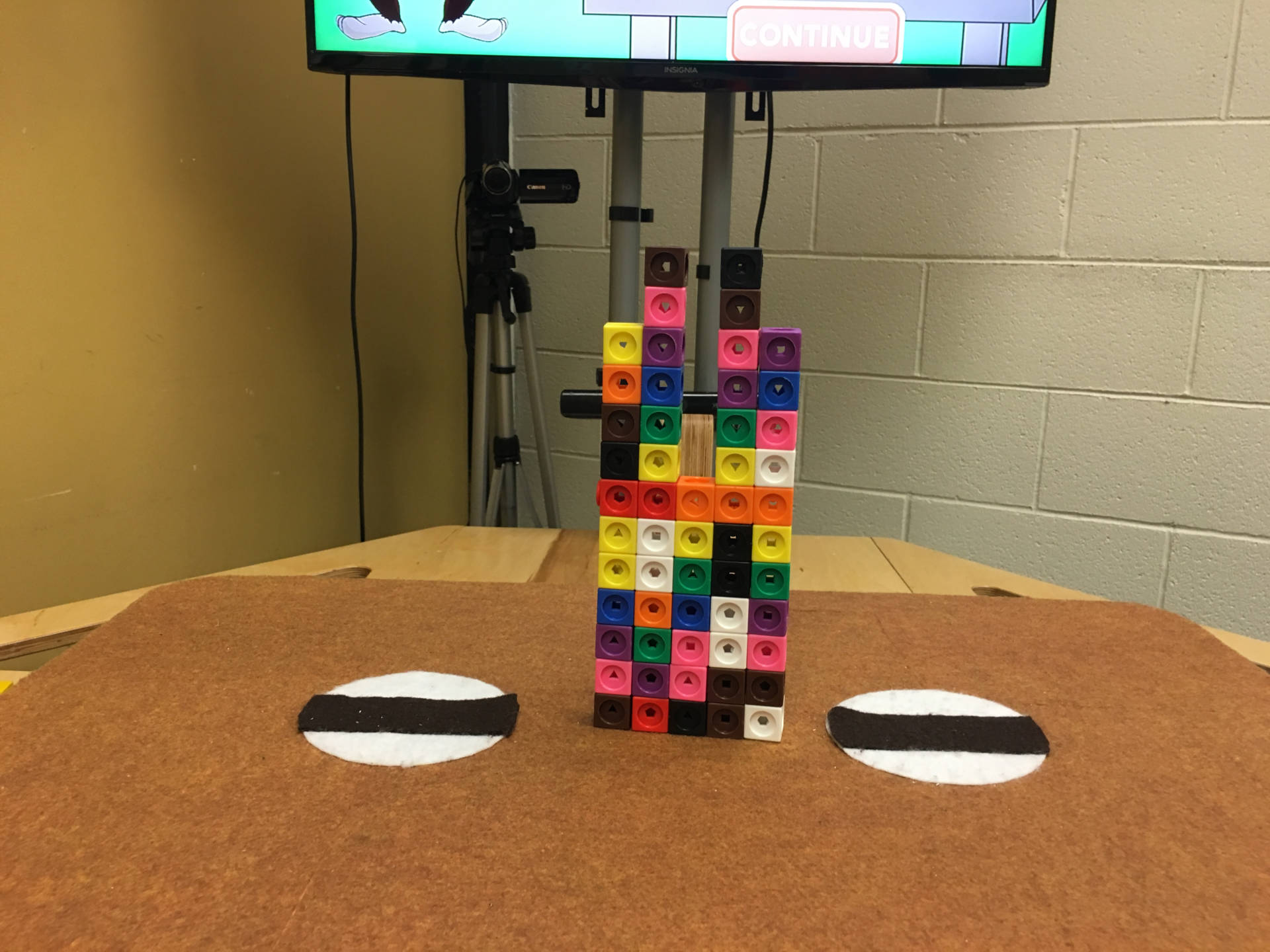 A tower of blocks on Nesra Yannier's earthquake table during an experiment at Forest Grove Elementary School.