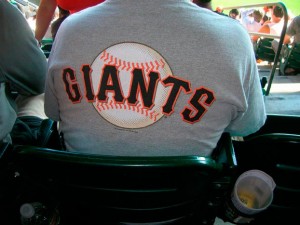 A fan wears a San Francisco Giants t-shirt.