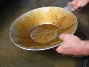 Mike Dunn demonstrates gold panning with material dredged from a California riverbed.