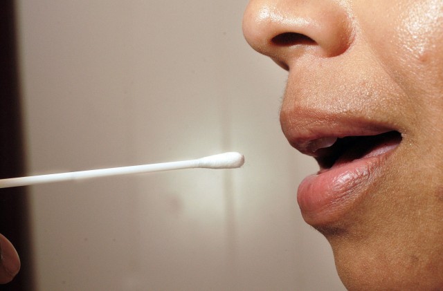 California law mandates that all those arrested for a felony — whether charged with a crime or not — should submit to a cheek swab. (William Thomas Cain/Getty Images)