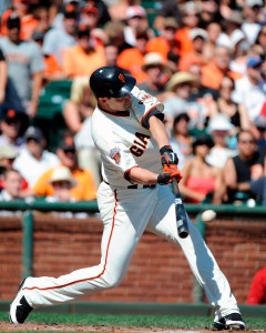 Pat Burrell of the San Francisco Giants hits a single against the Colorado Rockies. 