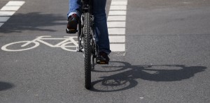 A cyclist pedals along a dedicated bike lane.