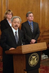 Mayor Ed Lee (center) announces that he will file misconduct charges against Sheriff Ross Mirkarimi and appoints Vicki Hennessy (left) as interim sheriff. (Mina Kim/KQED)