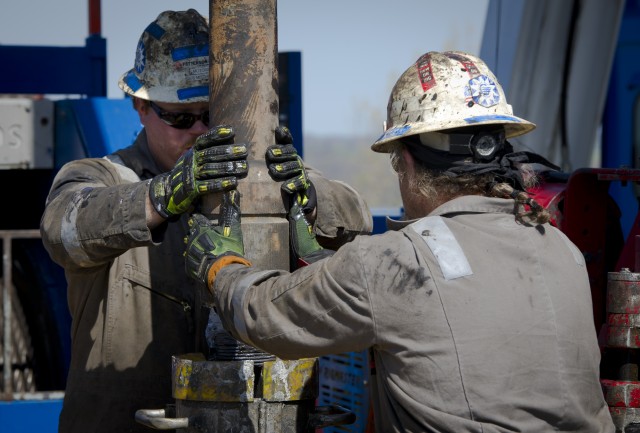 Workers change the pipes in a fracking operation. (Mladen Antonov/AFP/Getty Images)
