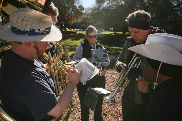 Kim Boyd, right, of the San Francisco Lesbian/Gay Freedom Band works with musicians during a Jan. 12 practice in Oakland for the inauguration parade. (James Tensuan/NewsHour)